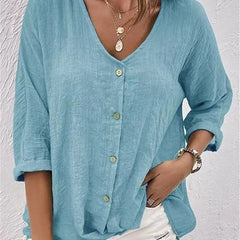 Medium blue V-neck button-front top with loose three-quarter sleeves.