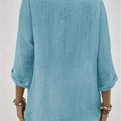 Light blue relaxed top with three-quarter sleeves and a plain back.