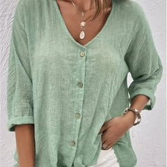 Mint green V-neck button-front top with loose three-quarter sleeves.