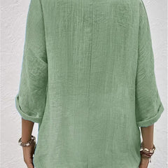 Mint green relaxed top with three-quarter sleeves and a plain back.