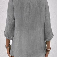 Heather gray relaxed top with three-quarter sleeves and a plain back.