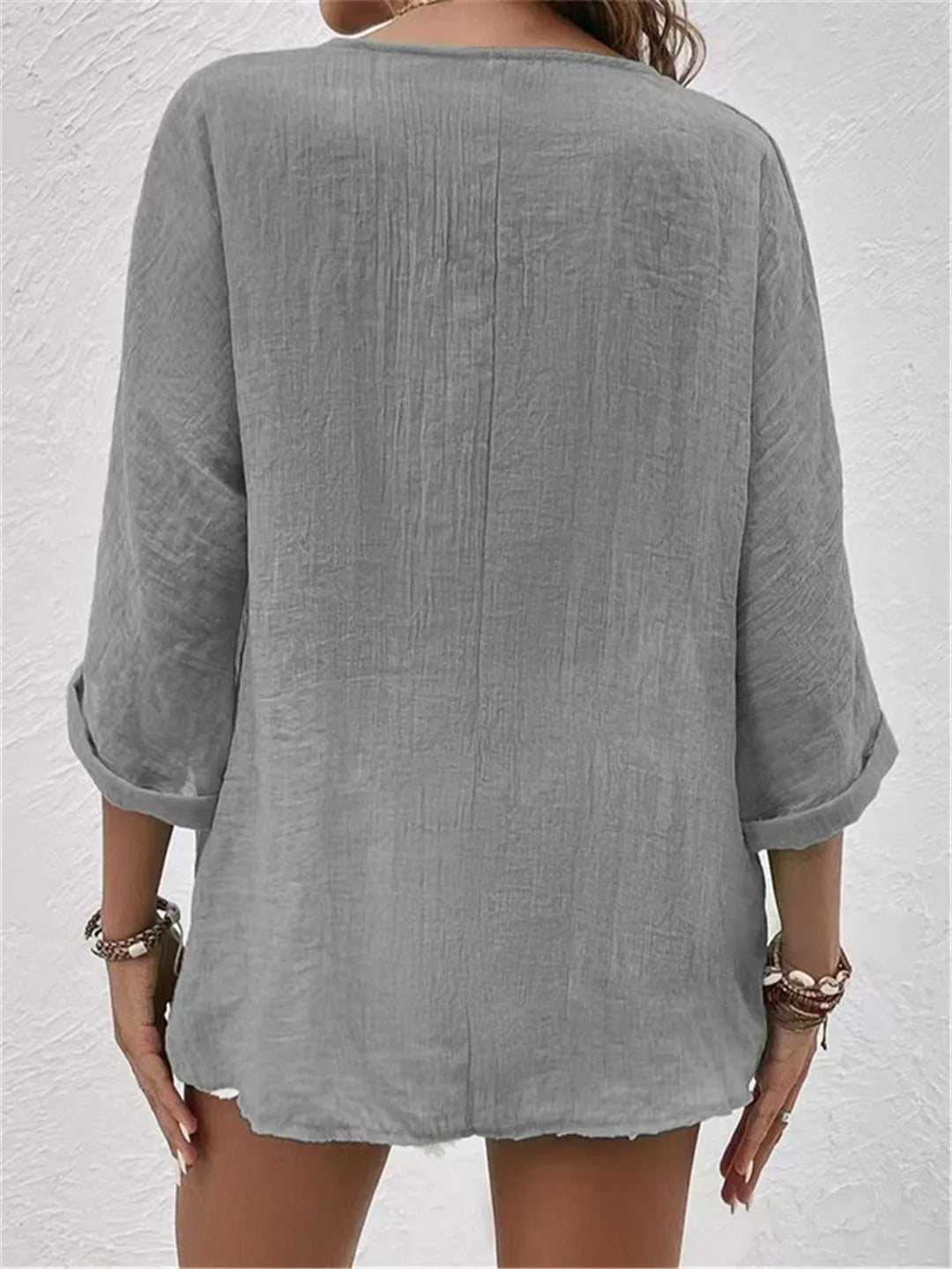 Heather gray relaxed top with three-quarter sleeves and a plain back.