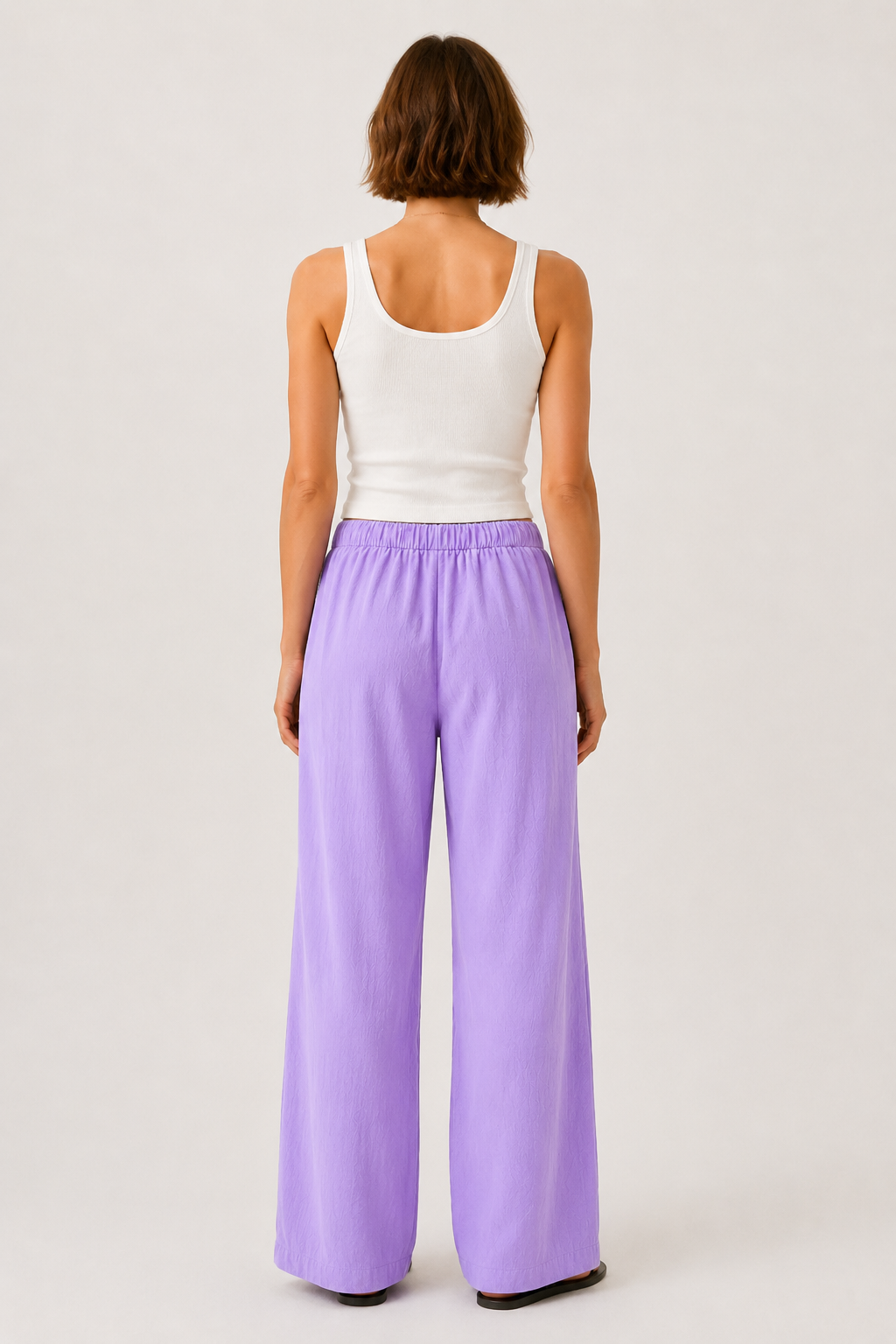 Lavender pants from the back with elastic waist and wide straight legs