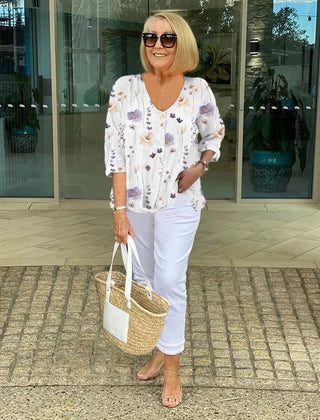 Printed button tunic top in white with floral pattern, three-quarter sleeves