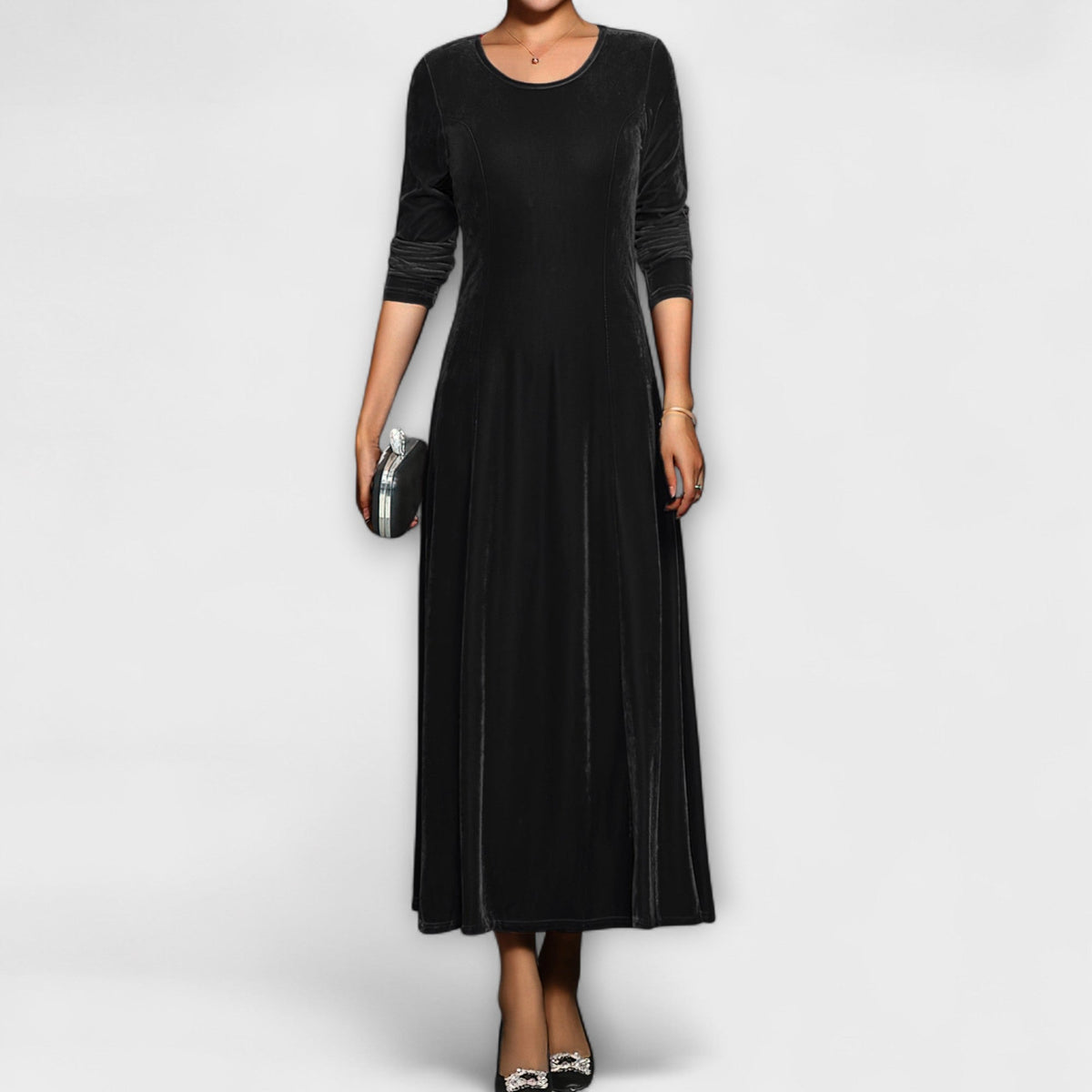 Black soft velvet dress with long sleeves, round neck, fitted bodice and midi skirt