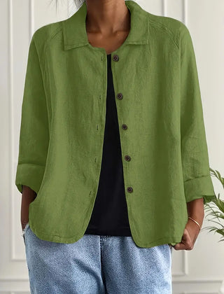 Green button-front light top with pointed collar and three-quarter sleeves