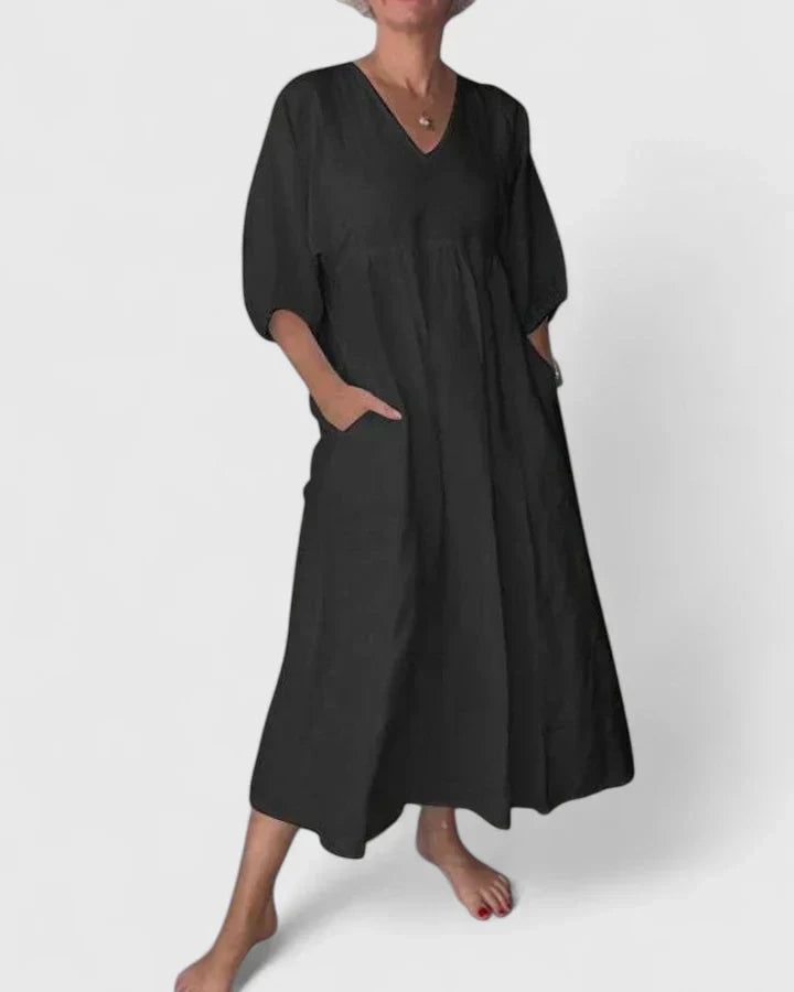 Black maxi dress with V-neck, loose fit, and draped short sleeves