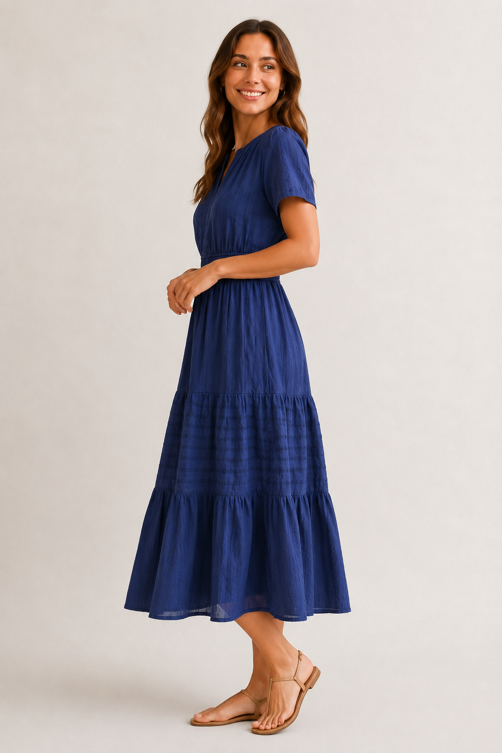 Royal blue tiered V-neck midi dress in side view with short sleeves and buttoned placket