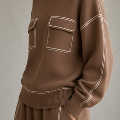 Women's brown knit set close-up: mock-neck sweatshirt with patch pockets, long sleeves