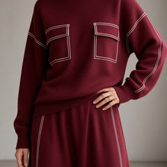 Women's burgundy knit set close-up: mock-neck sweatshirt and matching midi skirt