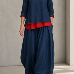Women's navy blue tunic and wide-leg pants set with red ruffle hem and 3/4 sleeves