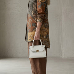 Paisley button-up shirt and loose brown pants with white handbag