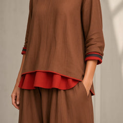 Women's brown tunic and wide-leg pants set with red ruffle hem, 3/4 sleeves, V neckline