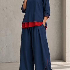 Women's navy blue tunic and wide-leg pants set with red ruffle hem and asymmetrical tunic