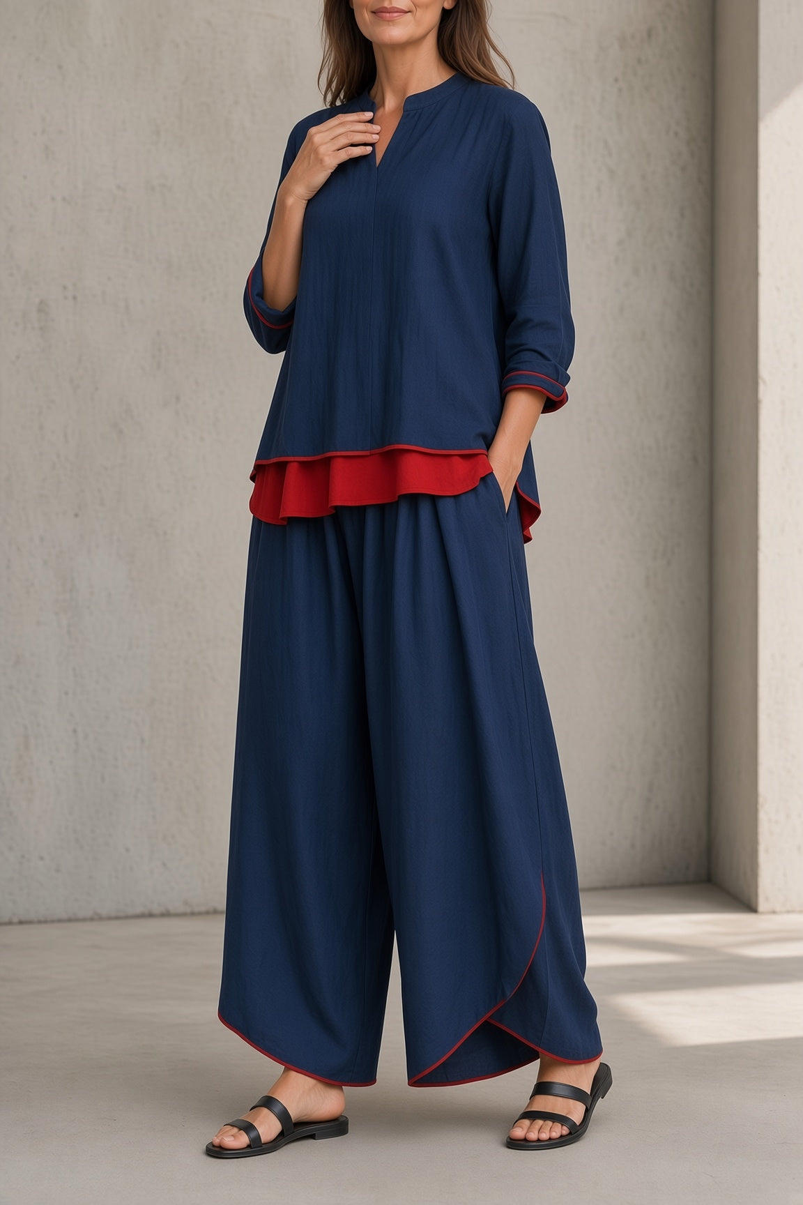Women's navy blue tunic and wide-leg pants set with red ruffle hem and asymmetrical tunic