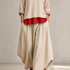 Women's beige tunic and wide-leg pants set with red ruffle hem and rolled sleeves