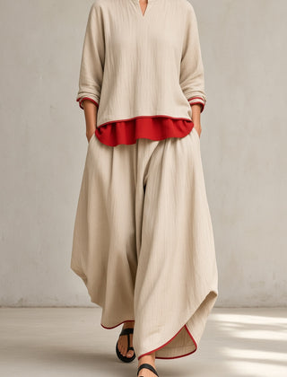 Women's beige tunic and wide-leg pants set with red ruffle hem and rolled sleeves