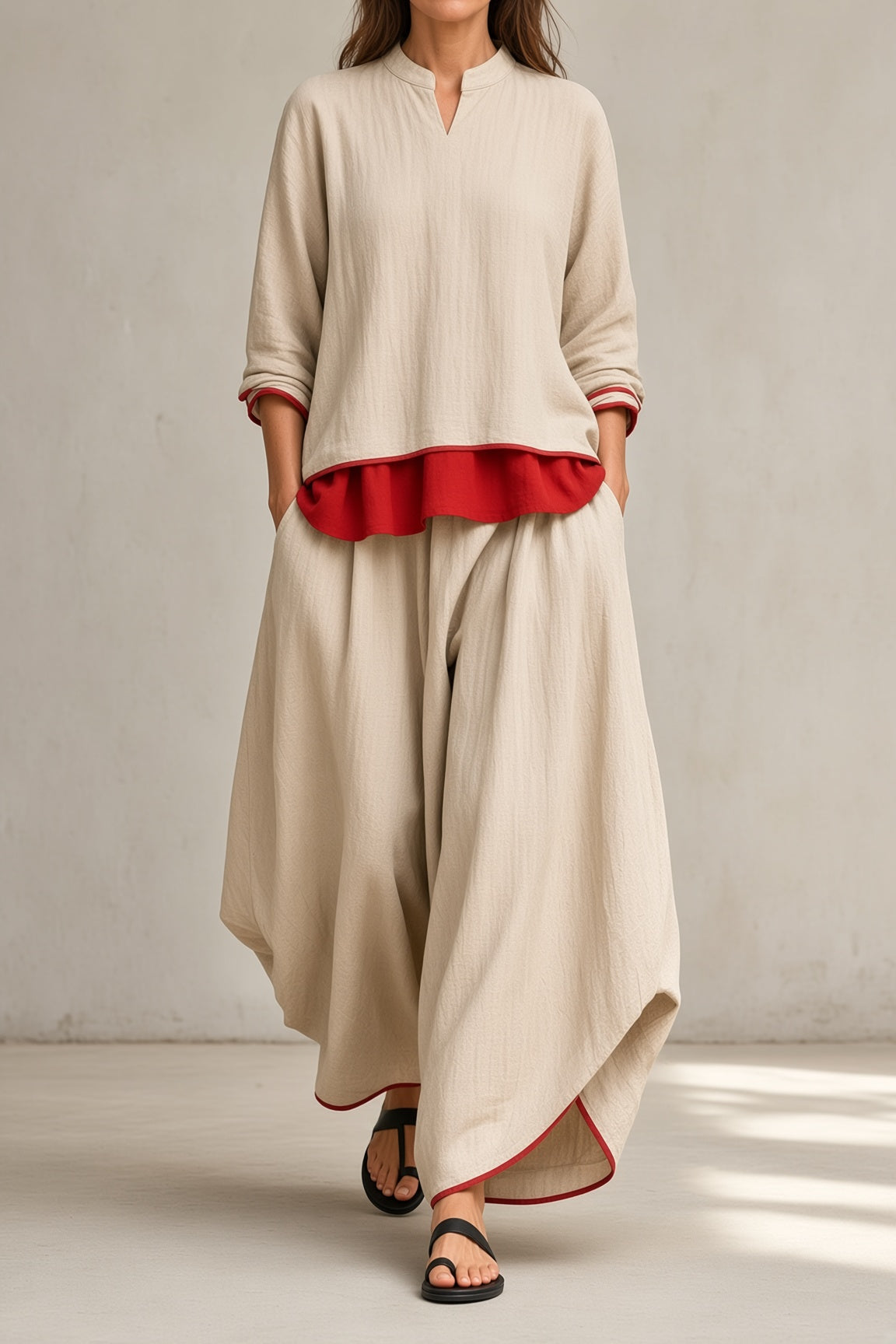 Women's beige tunic and wide-leg pants set with red ruffle hem and rolled sleeves