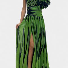 Striped one-shoulder maxi dress in green tones, gathered waist, side slit.