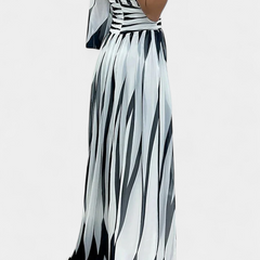 Striped one-shoulder maxi dress with open-back look and high side slit.