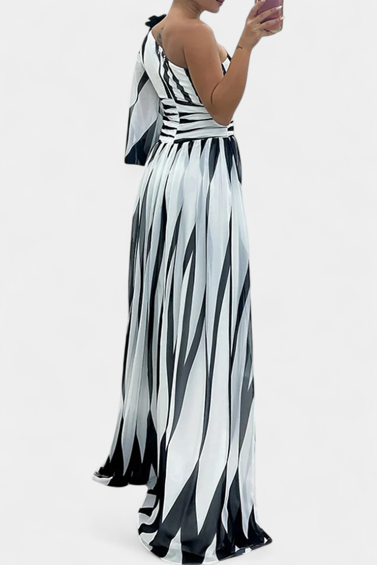 Striped one-shoulder maxi dress with open-back look and high side slit.