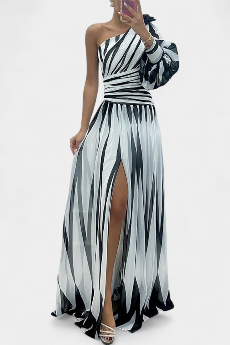 One-shoulder striped maxi dress in light and dark tones, draped bodice, side slit.