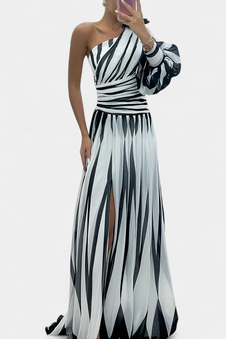 One-shoulder striped maxi dress in light and dark tones, ruched bodice, side slit.