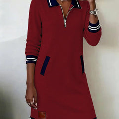Red long-sleeve cotton dress with quarter-zip, contrast collar and cuffs, striped hem, side pocket.