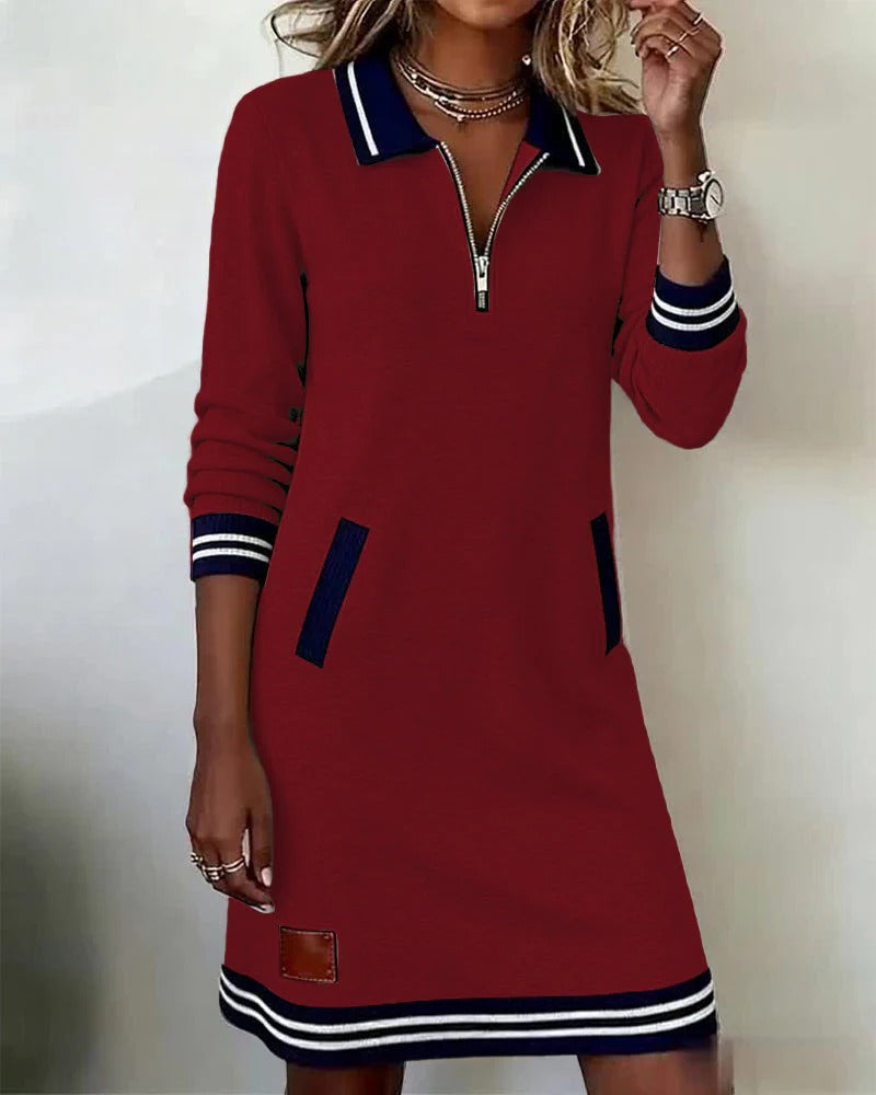 Red long-sleeve cotton dress with quarter-zip, contrast collar and cuffs, striped hem, side pocket.