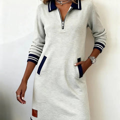 White long-sleeve cotton dress with half-zip placket, contrast cuffs, side pockets, striped hem