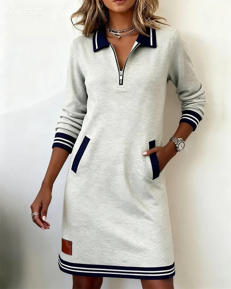 White long-sleeve cotton dress with half-zip placket, contrast cuffs, side pockets, striped hem