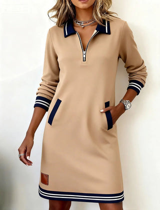 Tan long-sleeve cotton dress with half-zip neckline, contrast cuffs, side pockets, striped hem