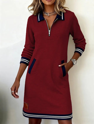 Burgundy long-sleeve cotton dress with half-zip, navy striped cuffs and hem, side pockets