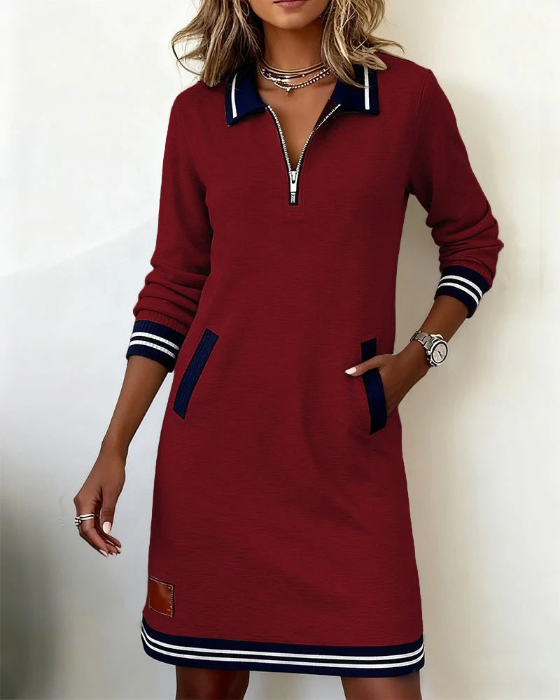 Burgundy long-sleeve cotton dress with half-zip, navy striped cuffs and hem, side pockets