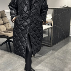 Kendall black quilted coat with leopard-print lining peeking from the cuffs