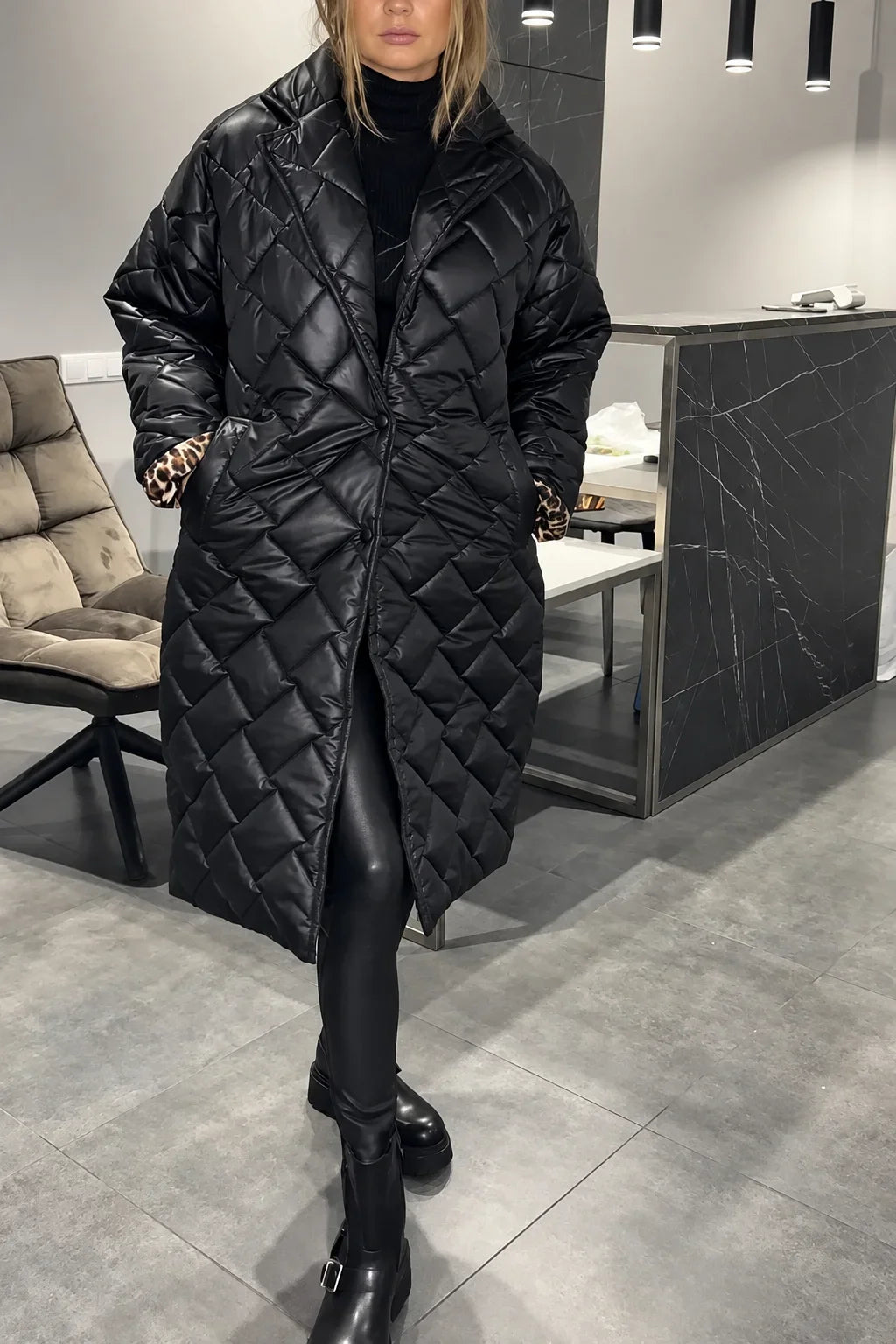 Kendall black quilted coat with leopard-print lining peeking from the cuffs