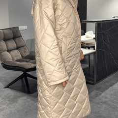 Kendall beige quilted coat shown from the side, with a long diamond-quilted design