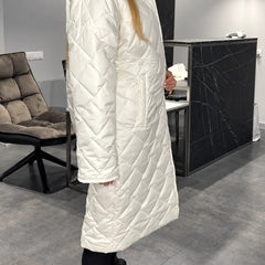 Kendall white quilted coat shown from the side, with a high collar and side pockets