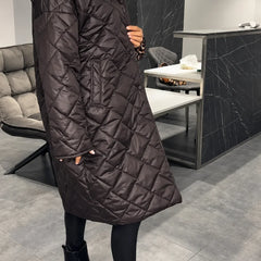 Kendall dark brown quilted coat shown from the side with a high collar