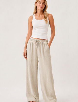 Light beige drawstring waist pants with relaxed wide-leg silhouette