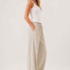 Light beige drawstring pants with relaxed wide-leg shape and side pockets
