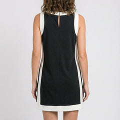 Black sleeveless dress with keyhole back and white hem trim
