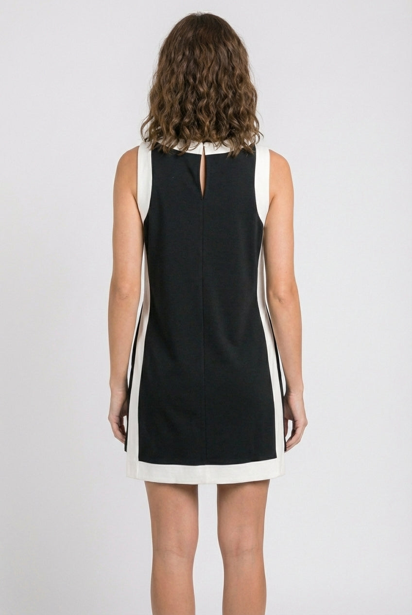 Black sleeveless dress with keyhole back and white hem trim