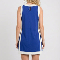 Back view of blue sleeveless tunic dress with white trim and center keyhole opening