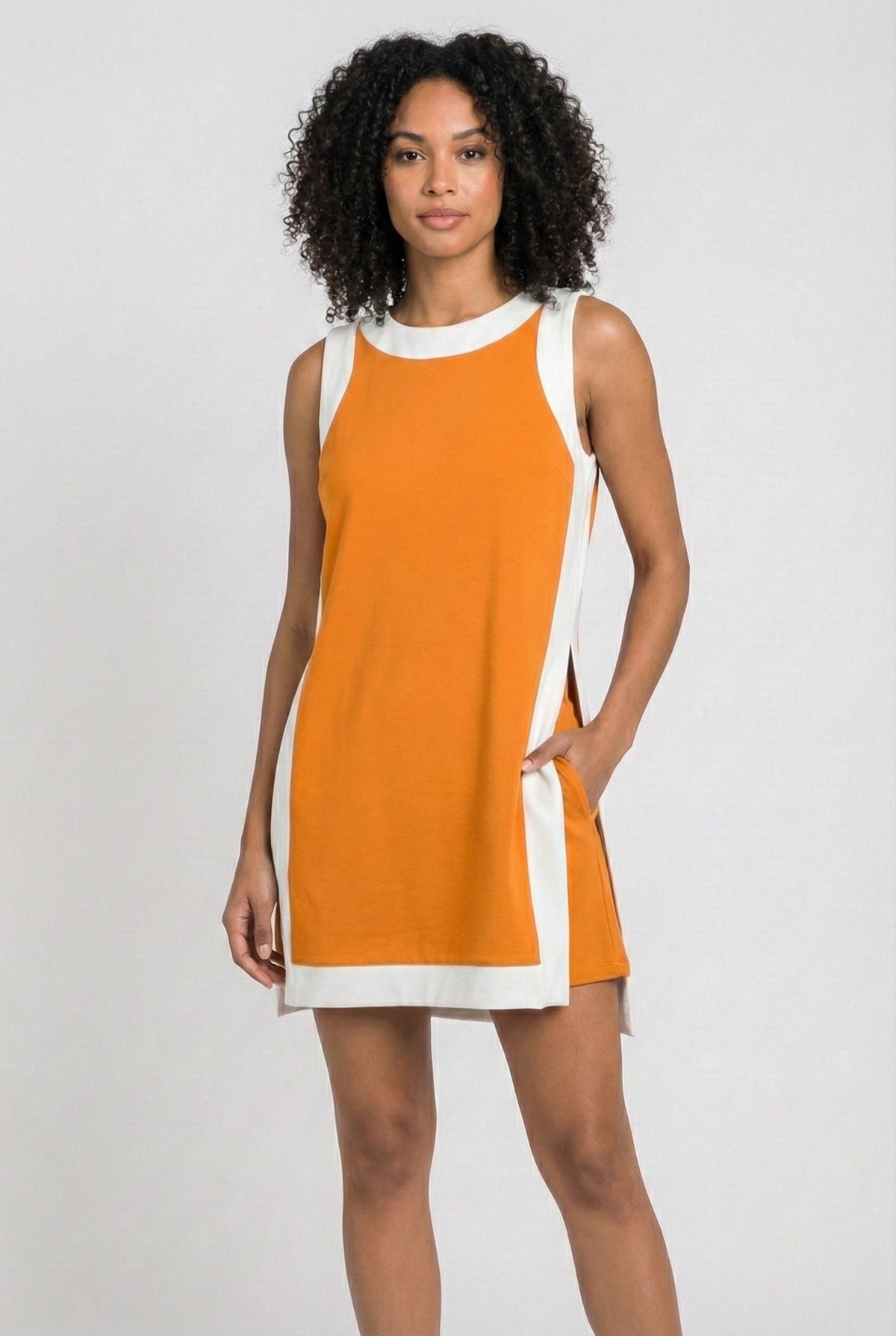 Orange sleeveless tunic dress with white crew neck and hem trim, side tie detail