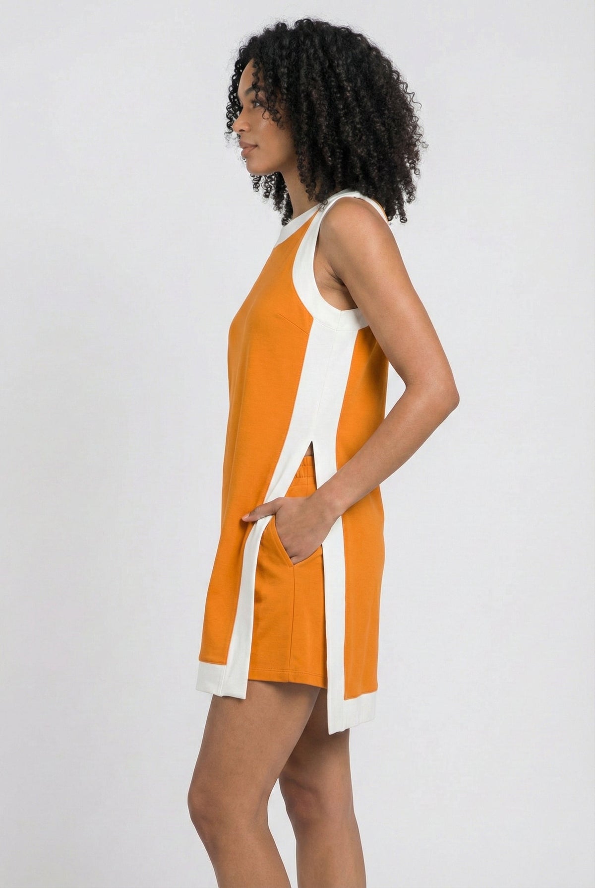 Orange sleeveless tunic dress with white side stripes and hanging tie at hip