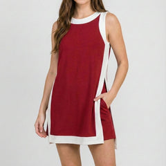 Crimson sleeveless dress with white side trim and crew neckline