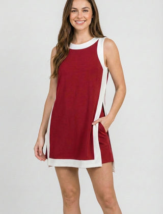 Crimson sleeveless dress with white side trim and crew neckline