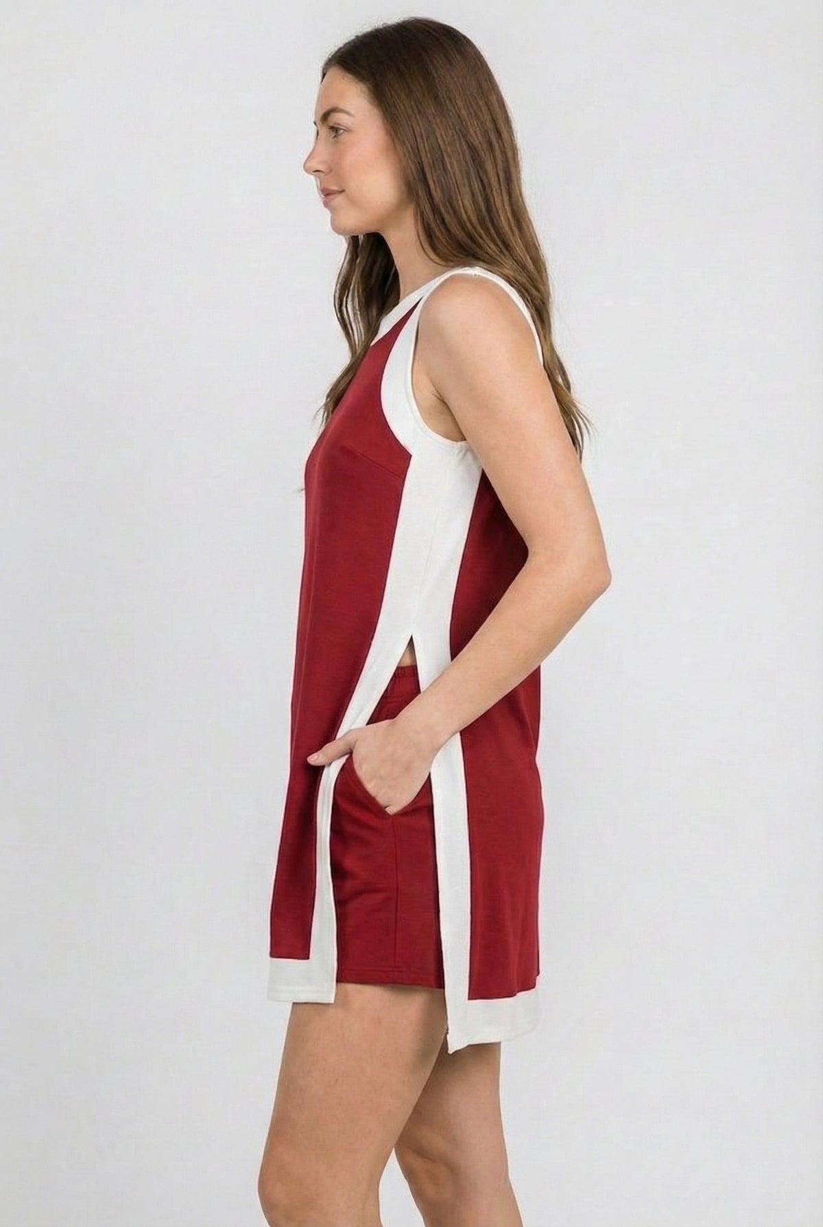 Crimson sleeveless dress with white side slits and crew neckline
