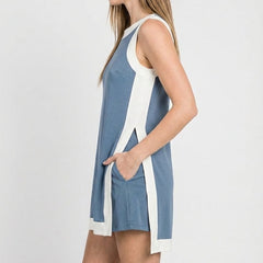 Blue sleeveless tunic dress from side view with white trim and long back hem slit
